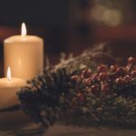 white pillar candle on brown wooden table