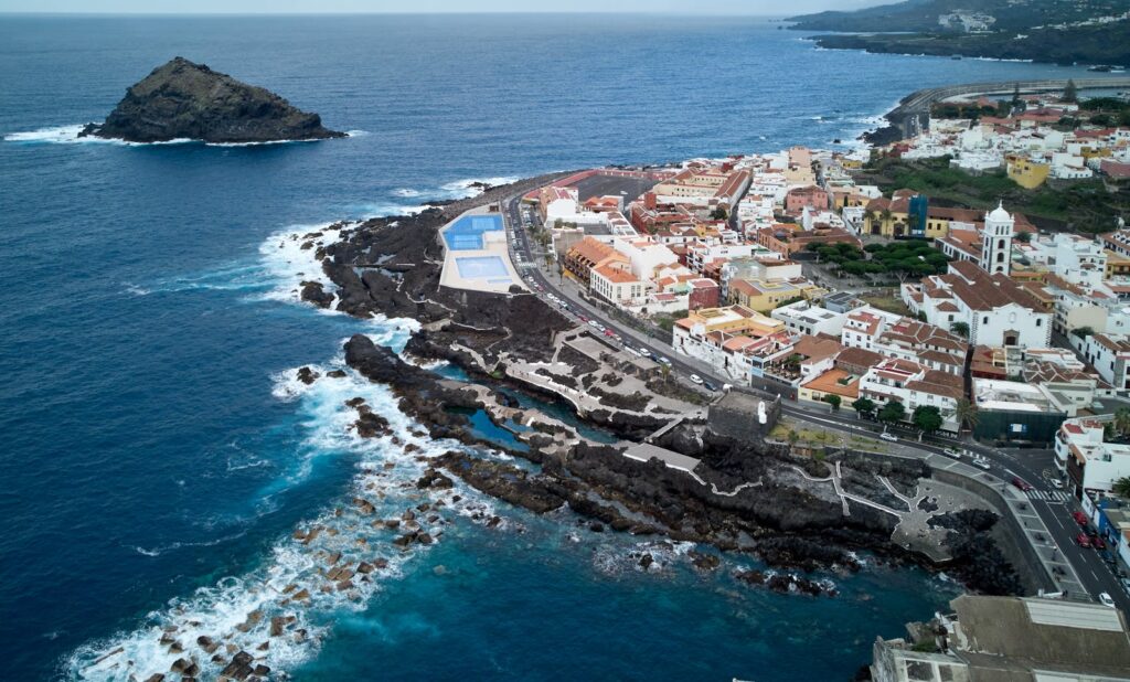 Stunning aerial view of Garachico's coastline in Tenerife, showcasing rugged rocks and charming town.