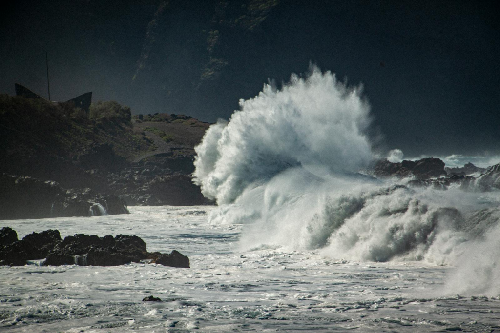 Powerful ocean waves crash against the rocky shore in Buenavista del Norte, Tenerife.