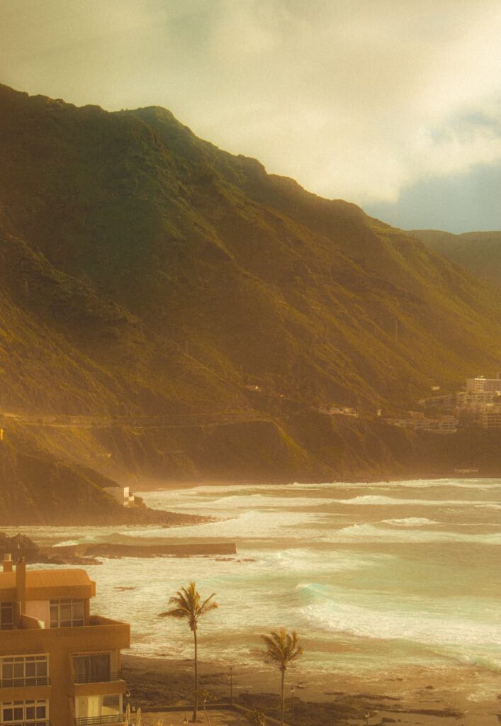 Captivating view of Punta del Hidalgo's cliffs and ocean waves in a serene, tropical setting.