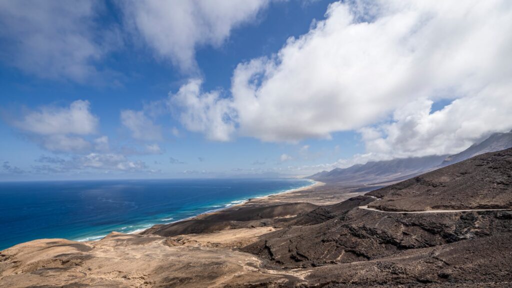 Stunning drone shot of the volcanic coast in Fuerteventura, showcasing dramatic landscapes.