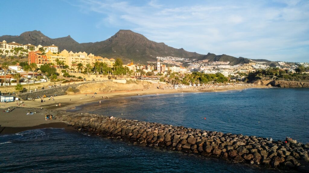 Scenic aerial view of Costa Adeje beach and town in Spain during sunset.