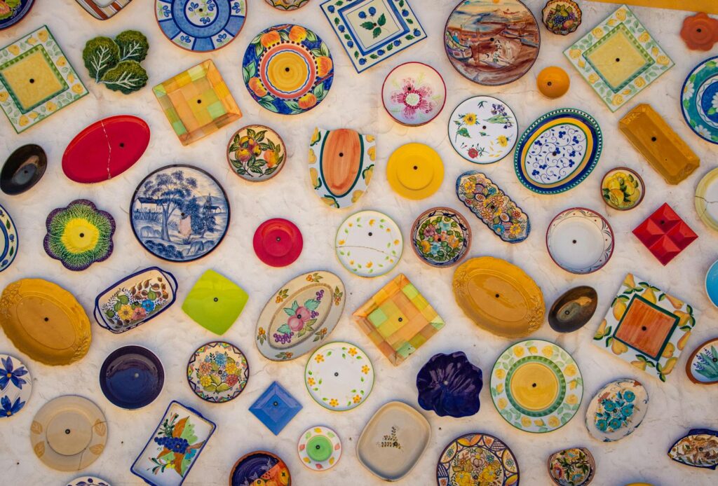 Colorful array of decorative ceramic plates exhibited in Faro, Portugal.