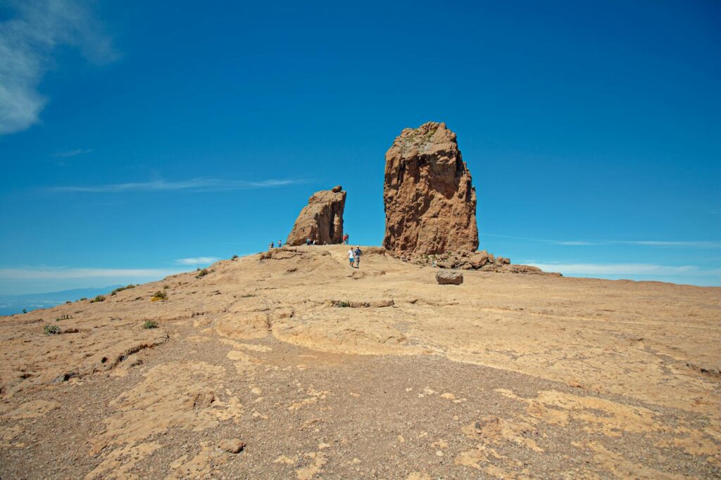 Explore the stunning rock formations under a bright blue sky, perfect for adventure seekers.