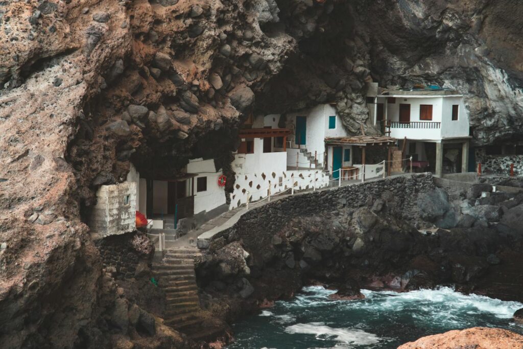 Picturesque houses built into rugged cliffs along La Palma's coastline.