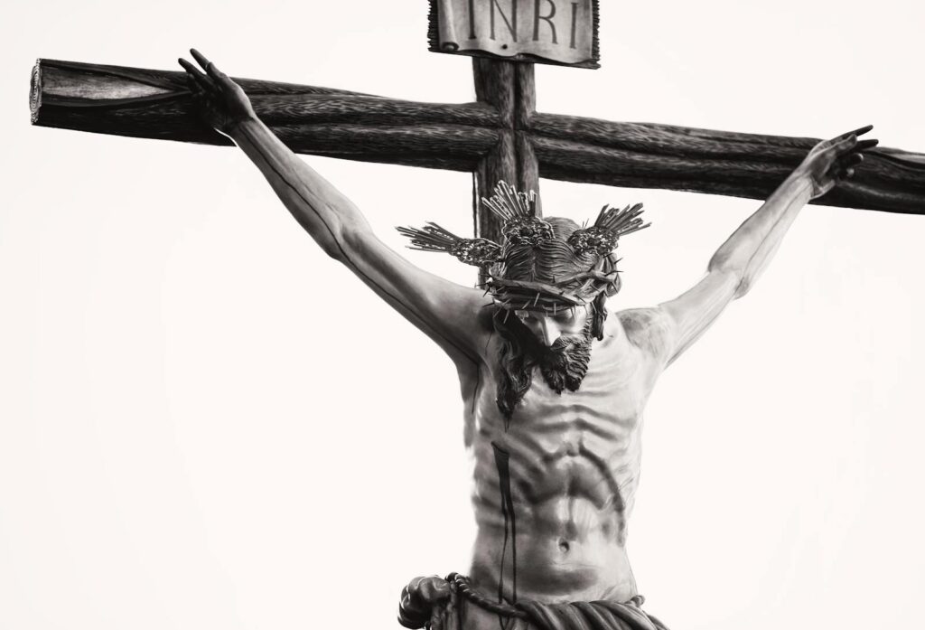 Monochrome depiction of Jesus crucified, showcasing religious artistry and sacrifice.