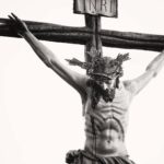 Monochrome depiction of Jesus crucified, showcasing religious artistry and sacrifice.