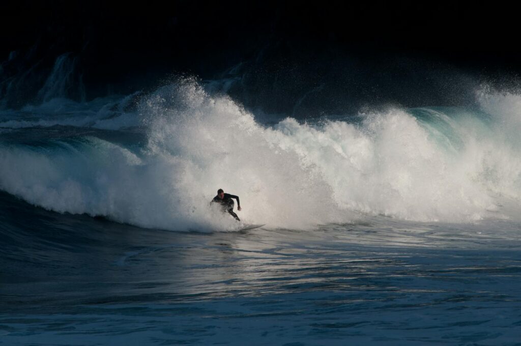 A dynamic image of a surfer riding powerful waves in Tenerife, capturing the thrill of ocean sports.