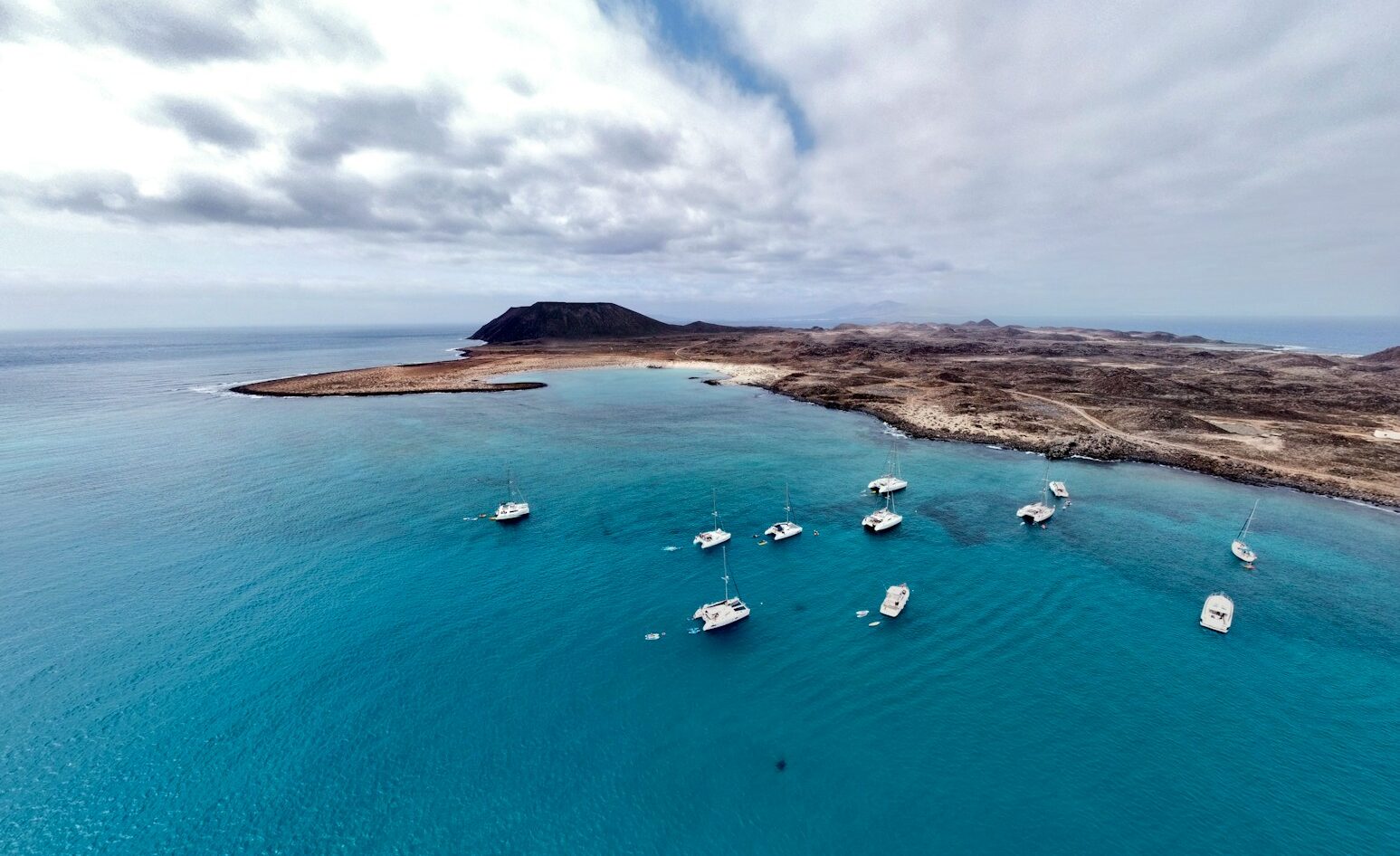 a group of boats floating on top of a body of water